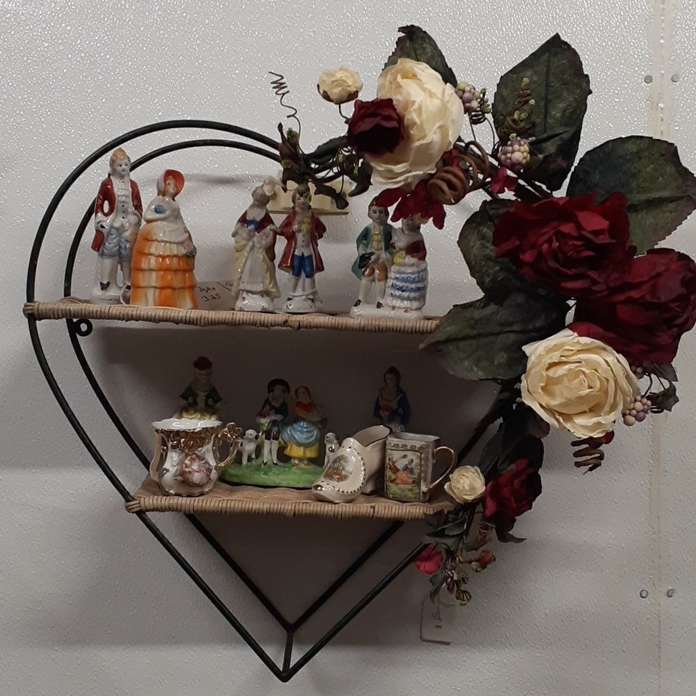 Lovely iron Heart with wicker shelving decorated with lucious red and white rose